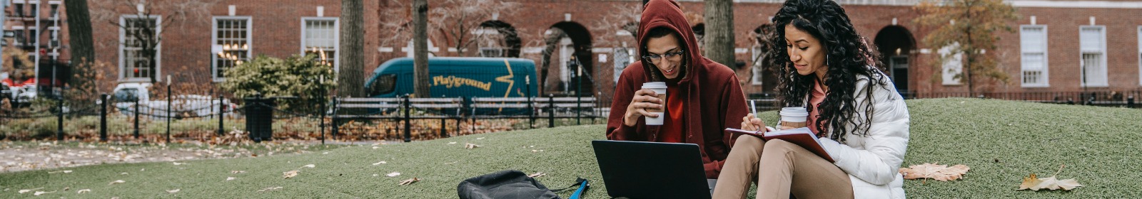 college students studying on lawn