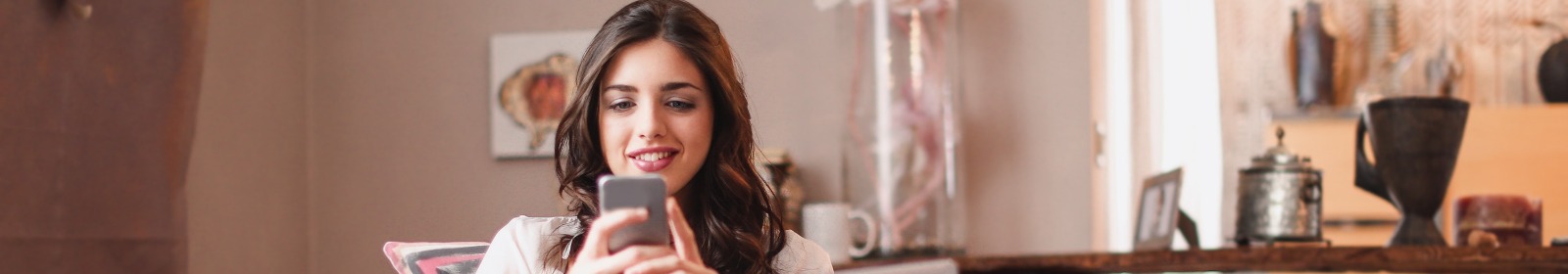 woman using phone in coffee shop